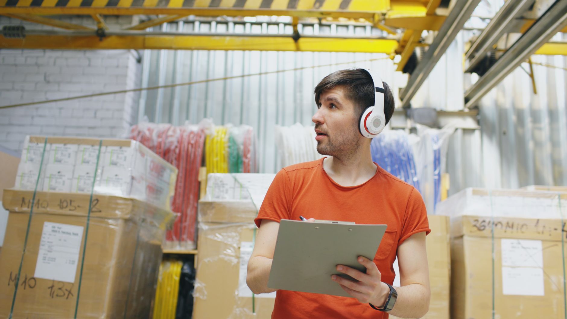 Warehouse staff counting inventory with a clipboard